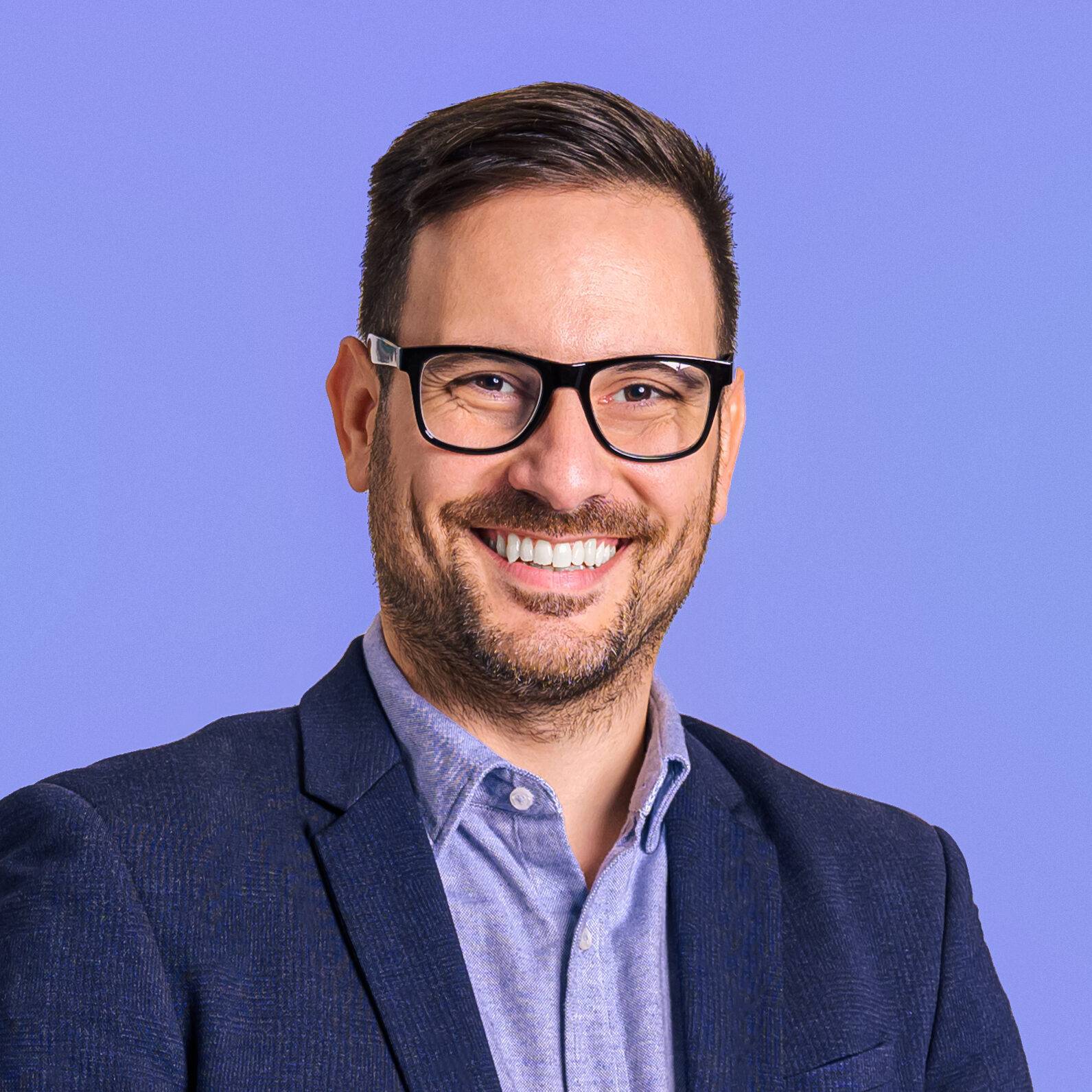 Smiling man in suit and glasses